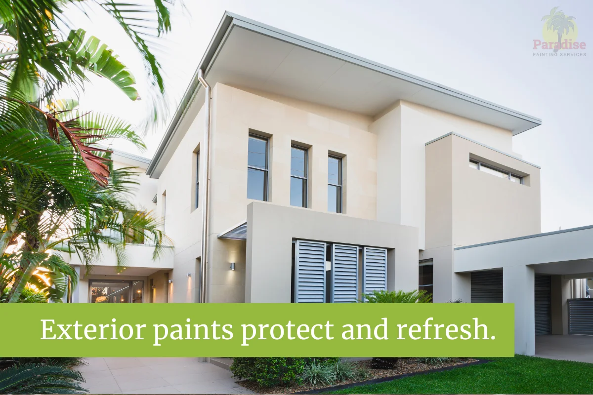 Modern home exterior with fresh beige paint surrounded by palm trees.